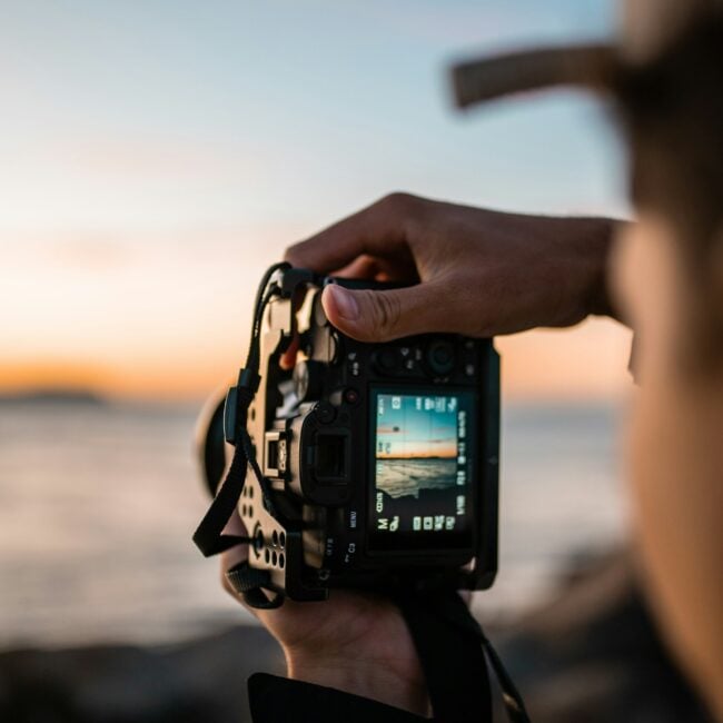 Photographer guiding a couple through interactive prompts during a candid, unscripted photoshoot in New England and NYC.